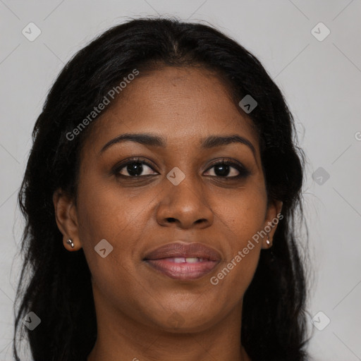 Joyful black young-adult female with long  brown hair and brown eyes