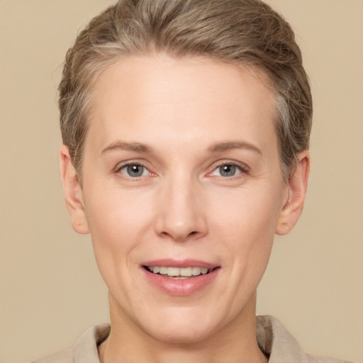 Joyful white adult female with short  brown hair and brown eyes