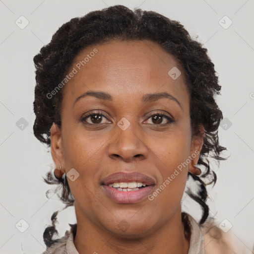 Joyful black adult female with short  brown hair and brown eyes