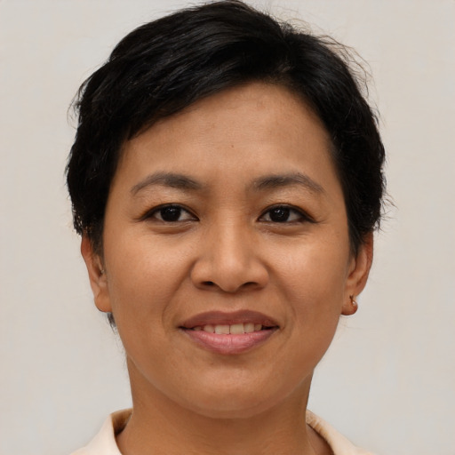 Joyful asian adult female with short  brown hair and brown eyes