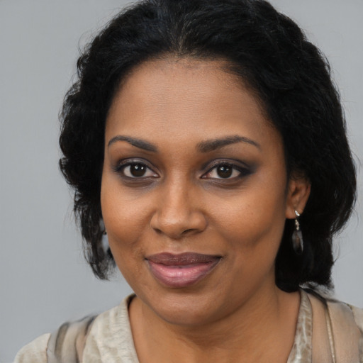 Joyful black adult female with medium  black hair and brown eyes