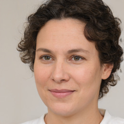 Joyful white adult female with medium  brown hair and brown eyes