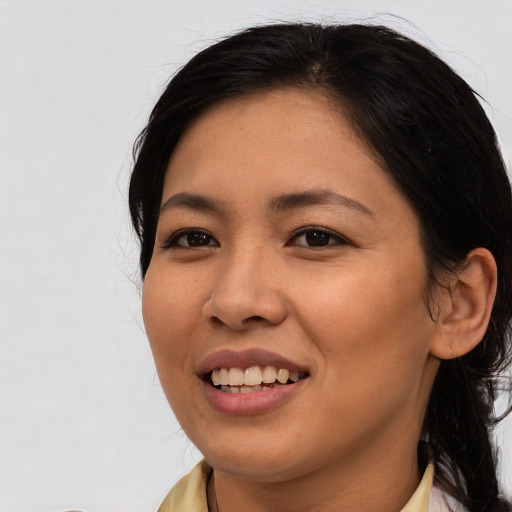 Joyful asian young-adult female with medium  brown hair and brown eyes