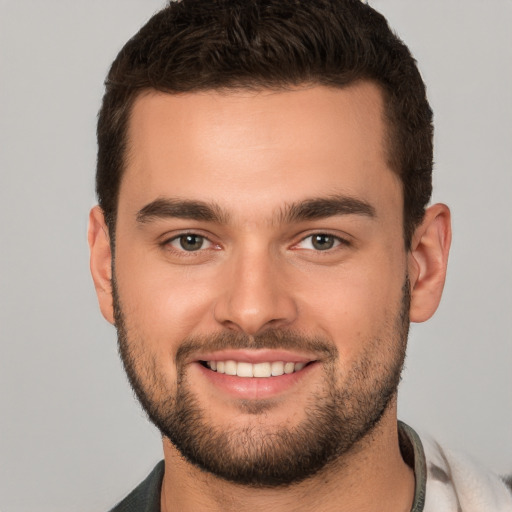 Joyful white young-adult male with short  brown hair and brown eyes