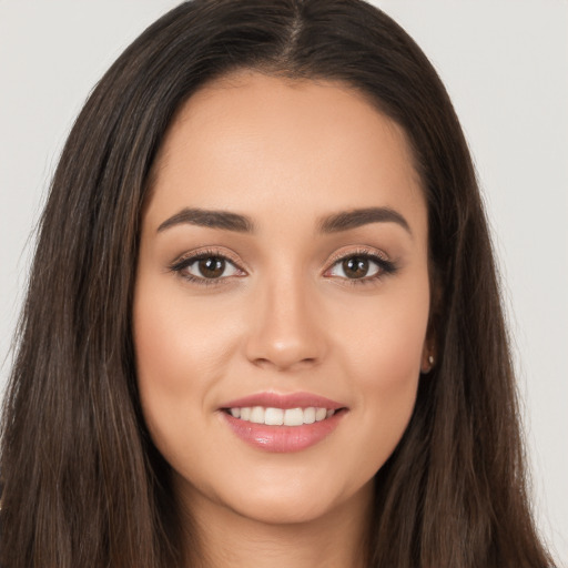 Joyful white young-adult female with long  brown hair and brown eyes