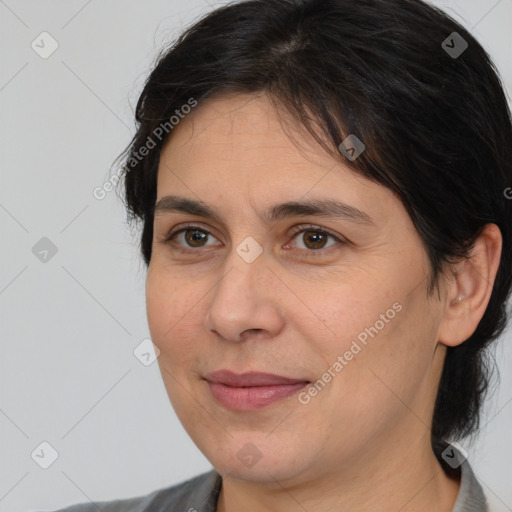 Joyful white adult female with medium  brown hair and brown eyes