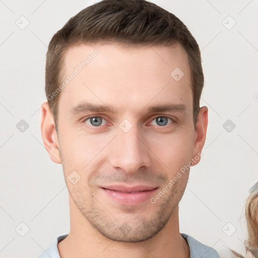 Joyful white young-adult male with short  brown hair and grey eyes