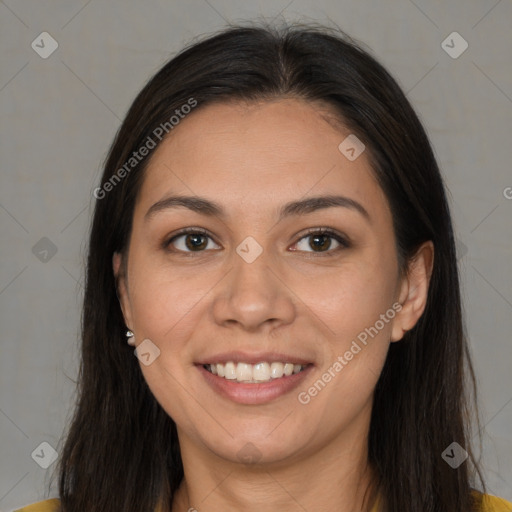 Joyful black young-adult female with long  brown hair and brown eyes