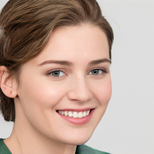 Joyful white young-adult female with medium  brown hair and green eyes