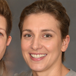 Joyful white adult female with medium  brown hair and brown eyes