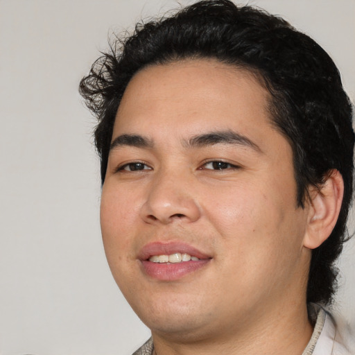 Joyful white young-adult male with medium  black hair and brown eyes