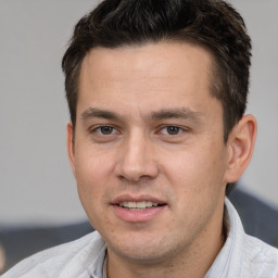 Joyful white adult male with short  brown hair and brown eyes