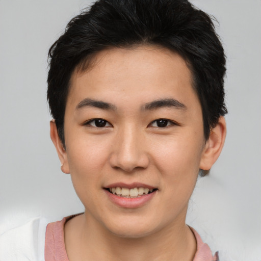 Joyful asian young-adult male with short  black hair and brown eyes