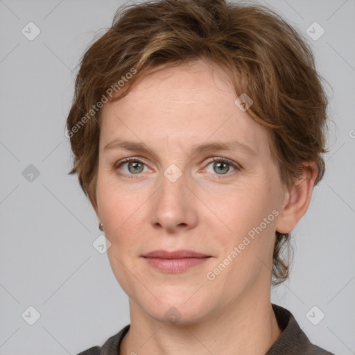 Joyful white adult female with medium  brown hair and grey eyes