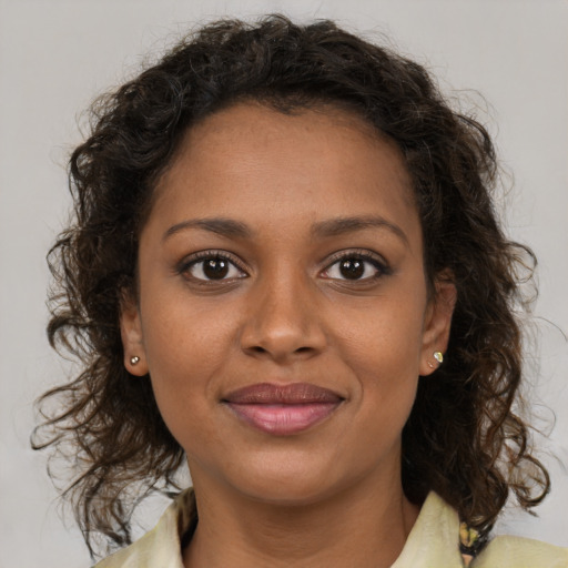Joyful black young-adult female with medium  brown hair and brown eyes