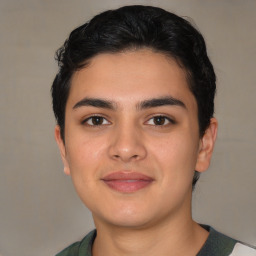 Joyful latino young-adult male with short  black hair and brown eyes