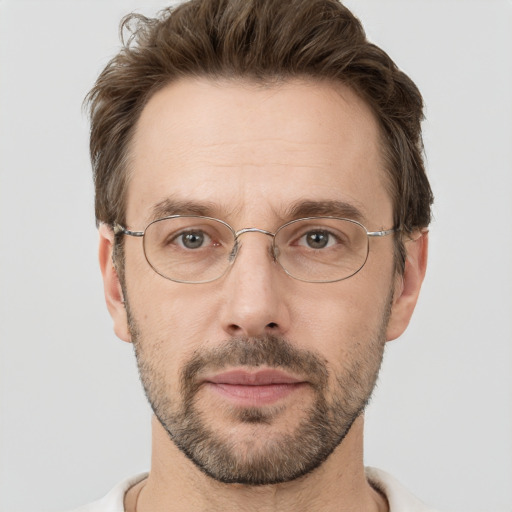 Joyful white adult male with short  brown hair and grey eyes