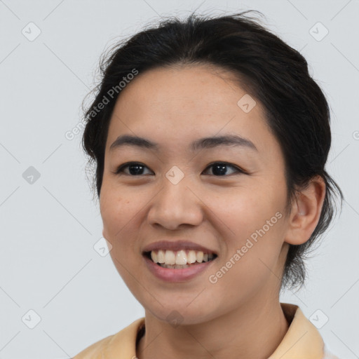 Joyful asian young-adult female with medium  black hair and brown eyes