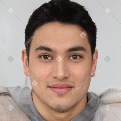 Joyful asian young-adult male with short  brown hair and brown eyes