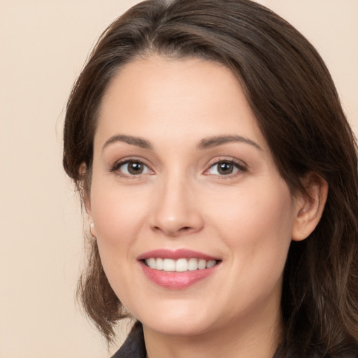 Joyful white young-adult female with long  brown hair and brown eyes