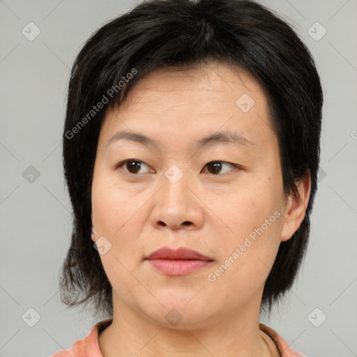 Joyful asian adult female with medium  brown hair and brown eyes