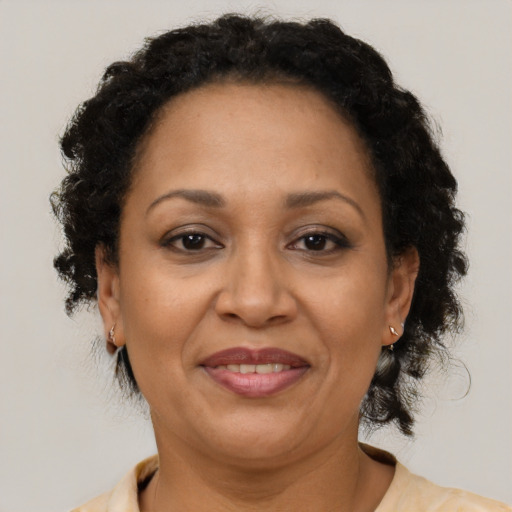 Joyful black adult female with short  brown hair and brown eyes