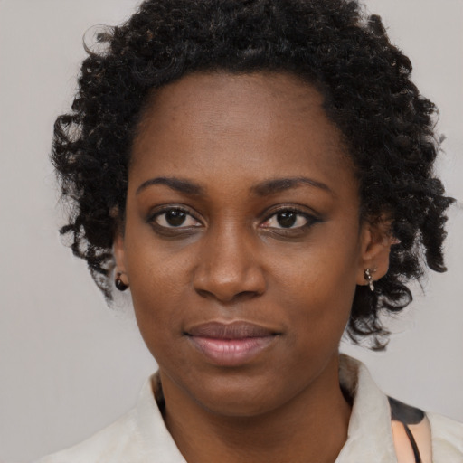 Joyful black young-adult female with medium  black hair and brown eyes