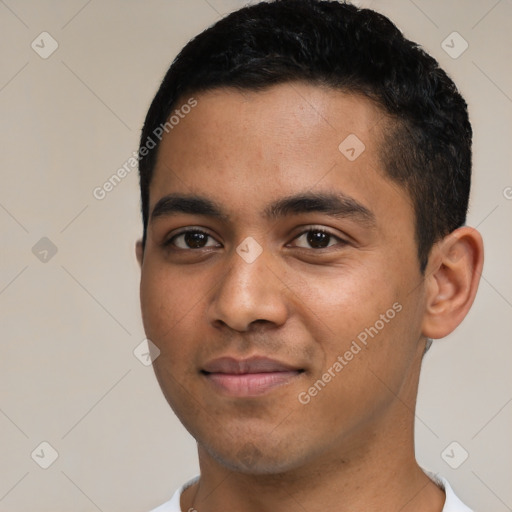 Joyful latino young-adult male with short  black hair and brown eyes