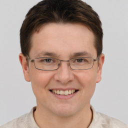 Joyful white adult male with short  brown hair and brown eyes