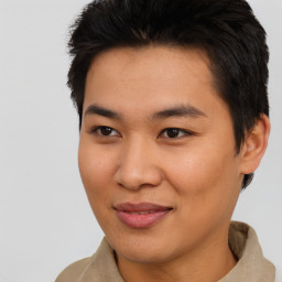 Joyful asian young-adult male with short  brown hair and brown eyes