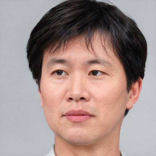 Neutral asian adult male with short  brown hair and brown eyes