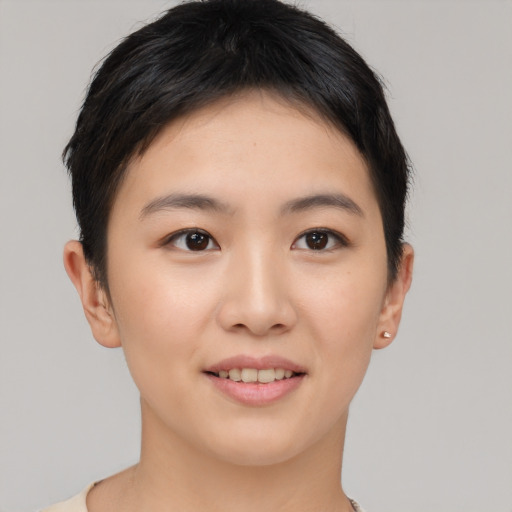 Joyful asian young-adult female with short  brown hair and brown eyes