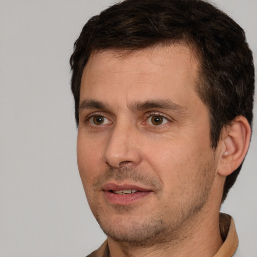 Joyful white adult male with short  brown hair and brown eyes