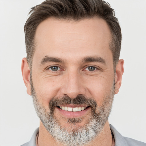 Joyful white adult male with short  brown hair and brown eyes