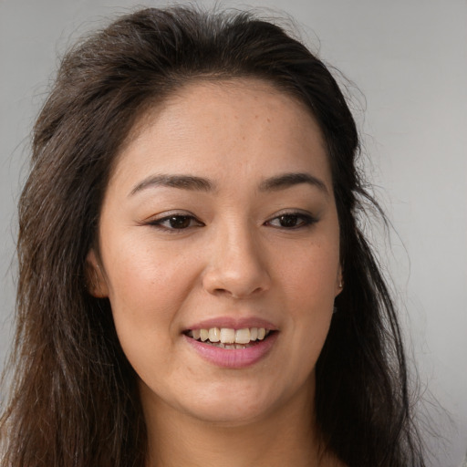 Joyful white young-adult female with long  brown hair and brown eyes