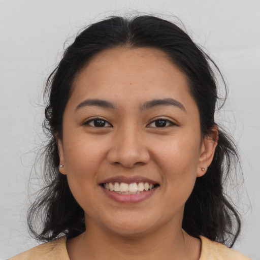 Joyful asian young-adult female with medium  brown hair and brown eyes