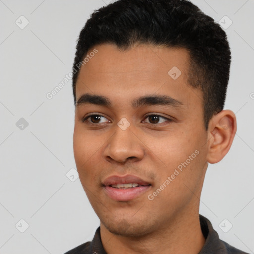 Joyful latino young-adult male with short  black hair and brown eyes