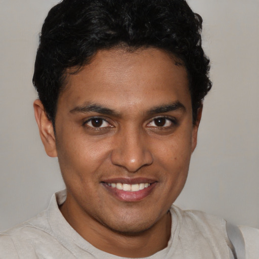 Joyful latino young-adult male with short  brown hair and brown eyes
