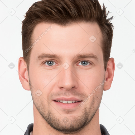 Joyful white young-adult male with short  brown hair and grey eyes