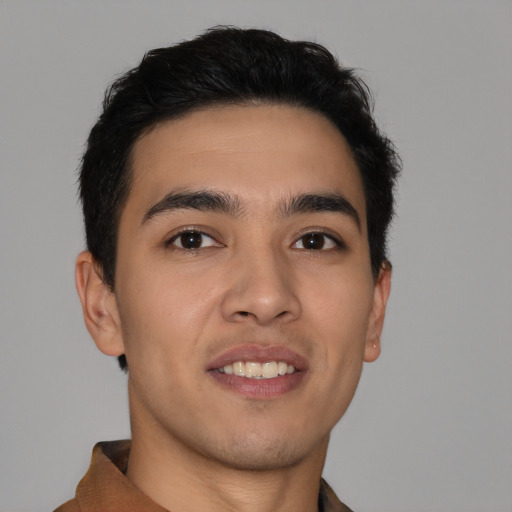 Joyful latino young-adult male with short  brown hair and brown eyes