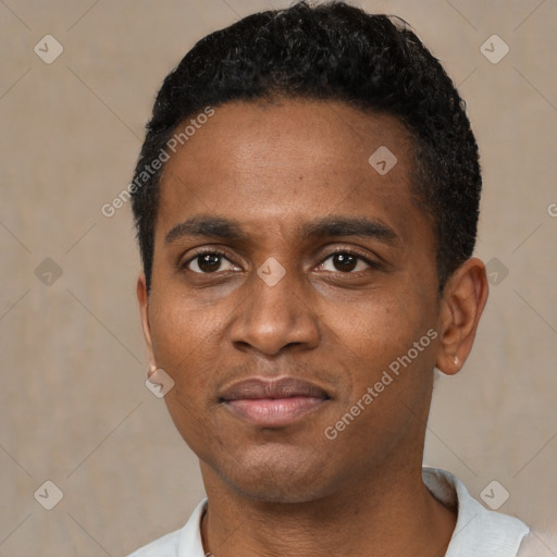 Joyful black young-adult male with short  black hair and brown eyes