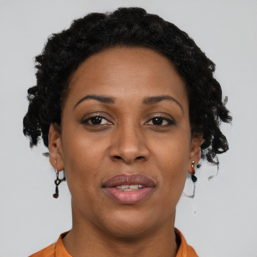 Joyful black adult female with short  brown hair and brown eyes