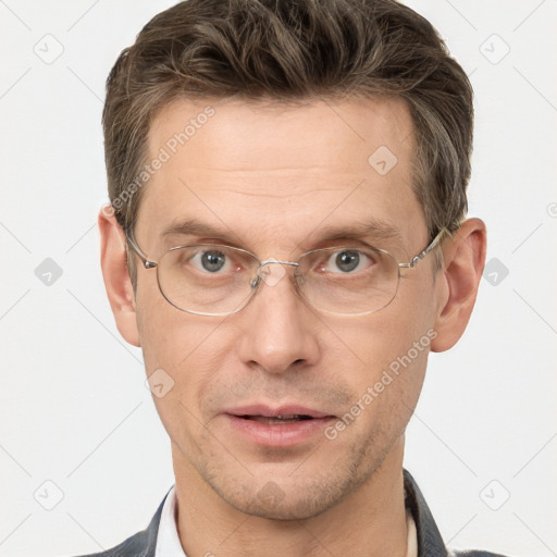 Joyful white adult male with short  brown hair and brown eyes