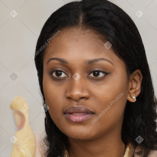 Joyful black young-adult female with long  black hair and brown eyes