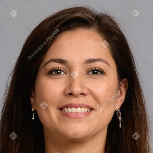 Joyful white adult female with long  brown hair and brown eyes