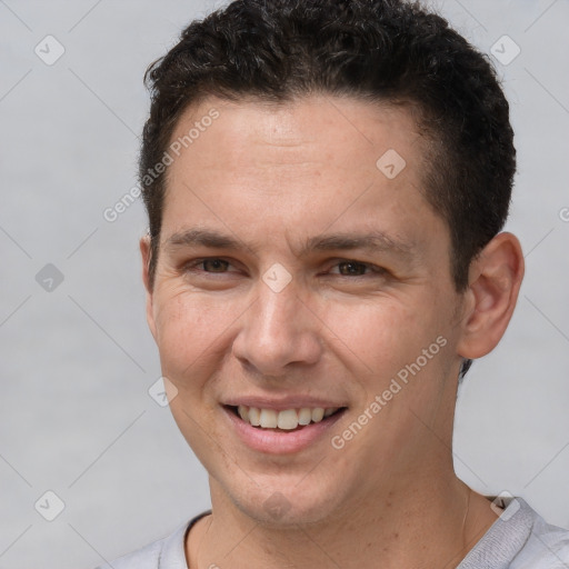 Joyful white adult male with short  brown hair and brown eyes