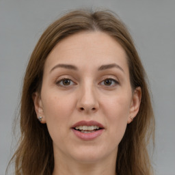 Joyful white young-adult female with medium  brown hair and grey eyes