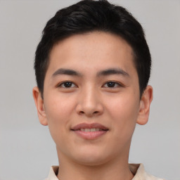 Joyful asian young-adult male with short  brown hair and brown eyes