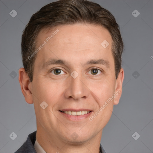 Joyful white adult male with short  brown hair and brown eyes