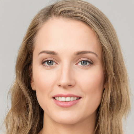 Joyful white young-adult female with long  brown hair and grey eyes